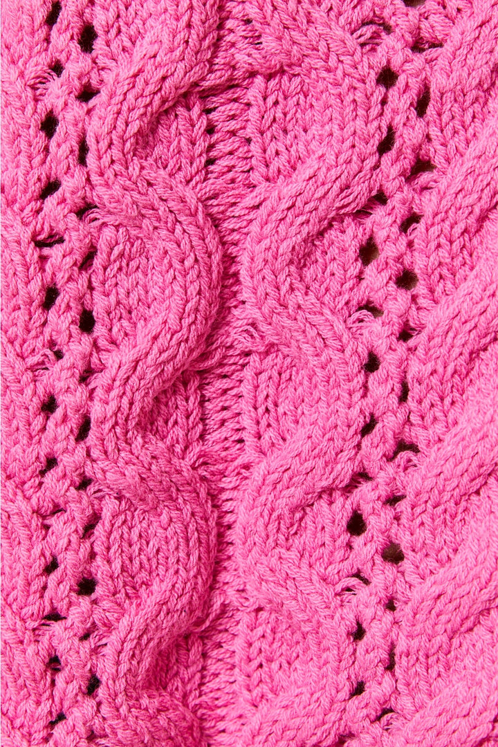 Close up of pink cable knit sweater