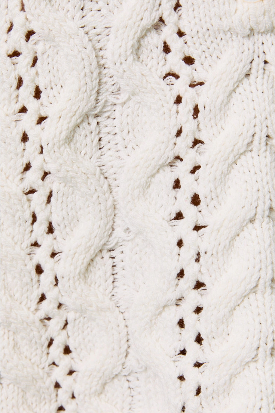 Close up of white cable knit sweater