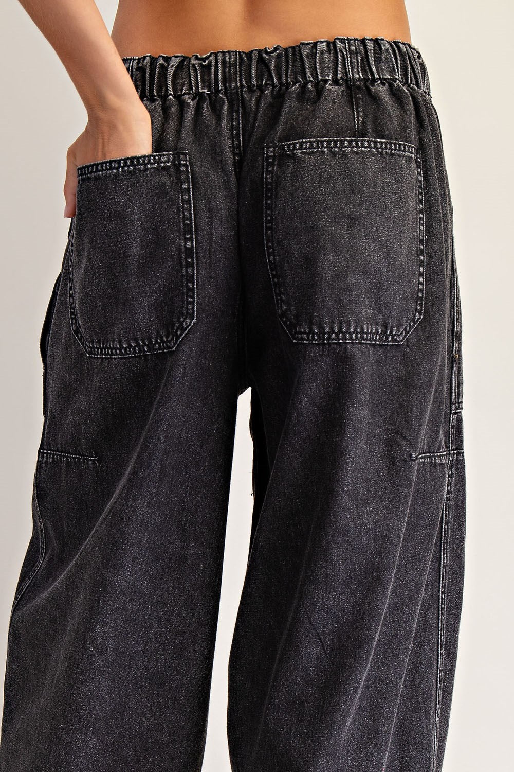 Black denim wide-leg pants on a plain background