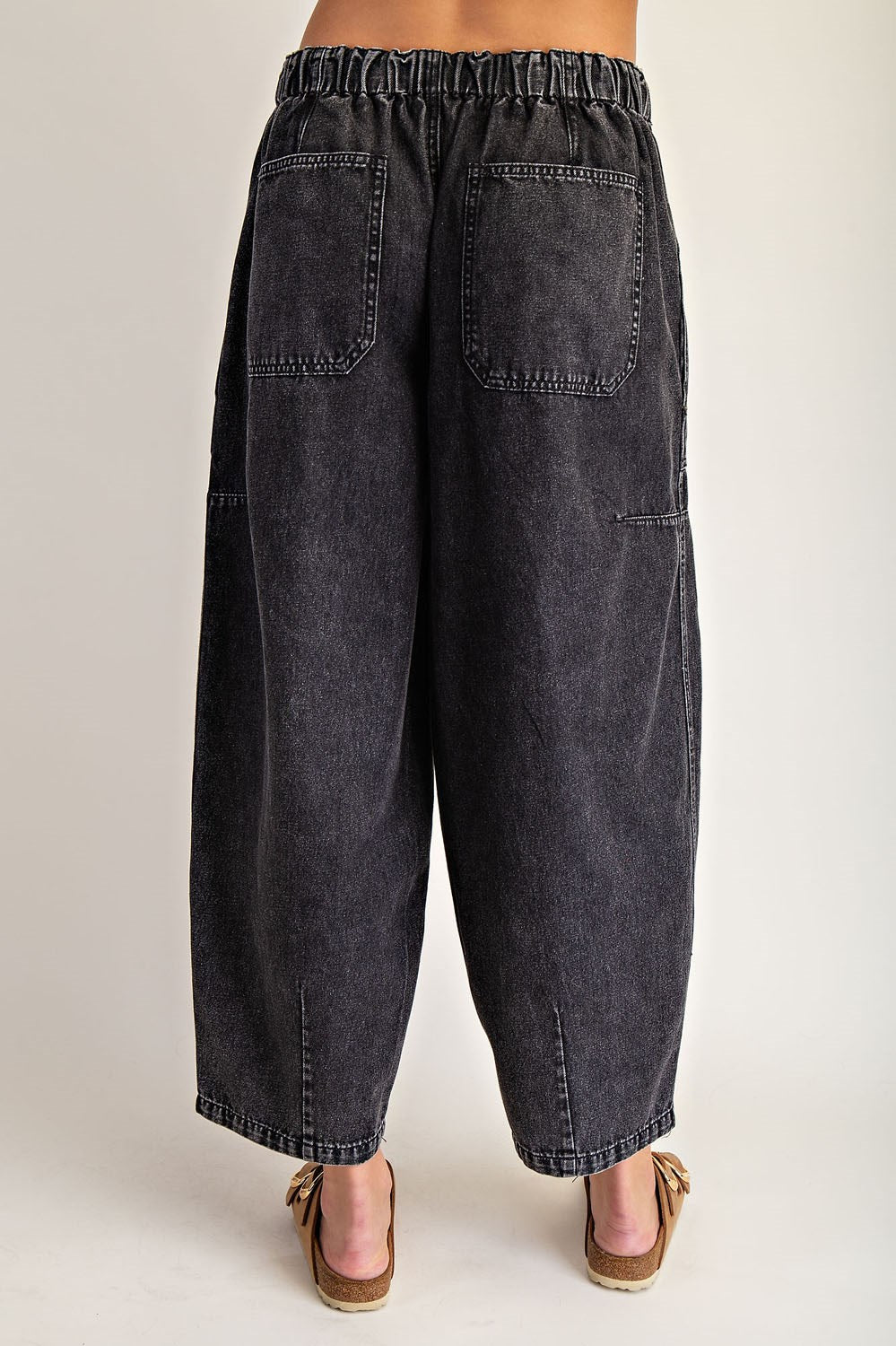 Black denim wide-leg pants worn by a person on a plain background