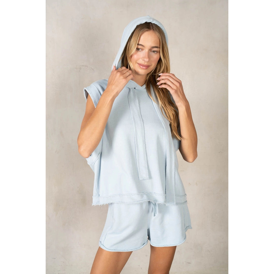 Woman wearing matching light blue set on plain background
