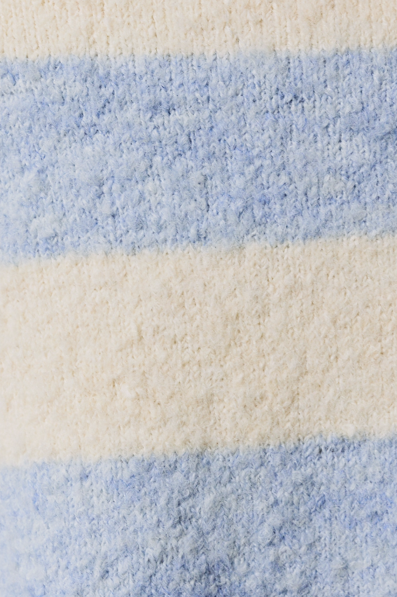 A close-up of a plush, textured fabric with horizontal stripes in light blue and cream.