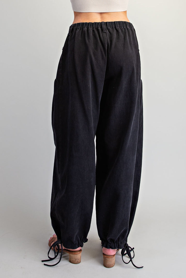 Black wide-leg jogger pants with an elastic waistband and drawstring ankle cuffs, shown from the back on a model against a light gray background.
