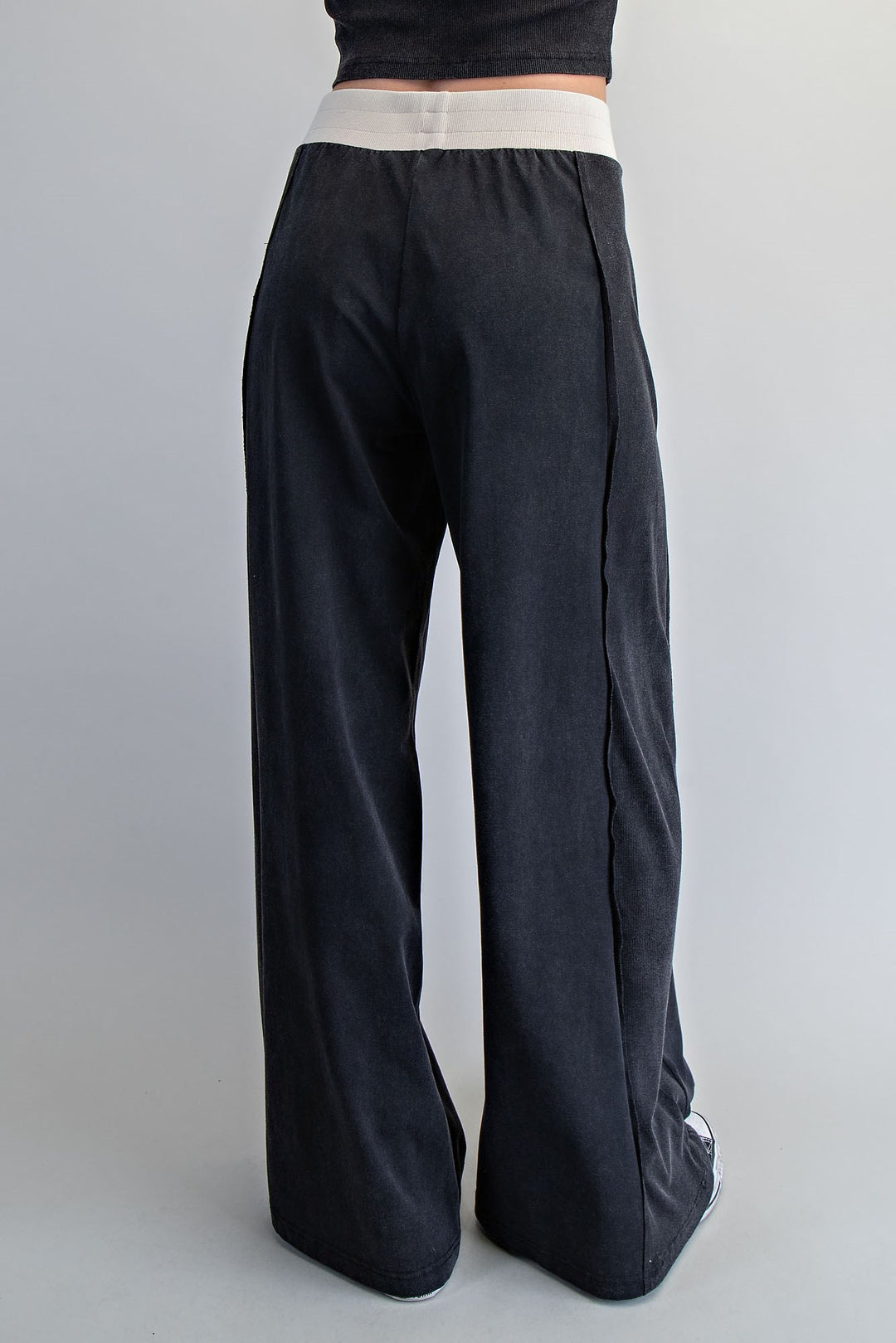 Black wide-leg pants on a plain background