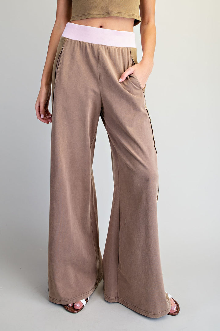 Brown wide-leg pants worn by a person on a plain background
