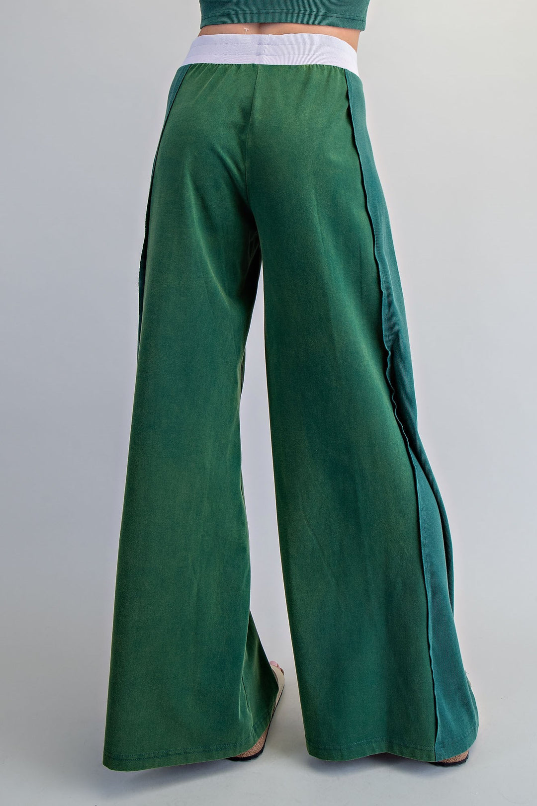 Green wide-leg pants on a plain background
