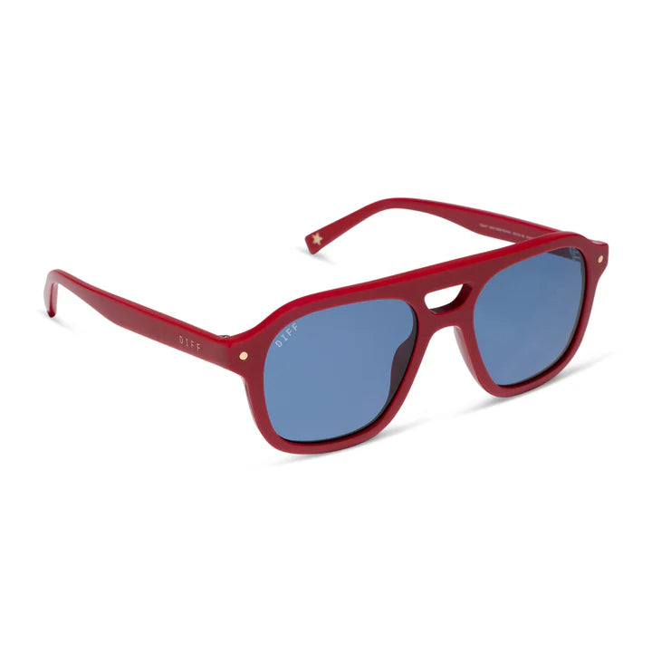 A pair of square-frame sunglasses with a translucent red acetate frame and blue mirrored lenses, shown at a three-quarter angle on a white background.