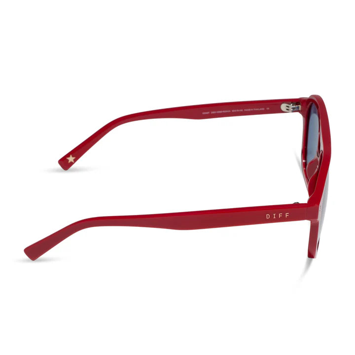 Red acetate sunglasses with a square frame, featuring a small gold star on the left temple and the brand name &