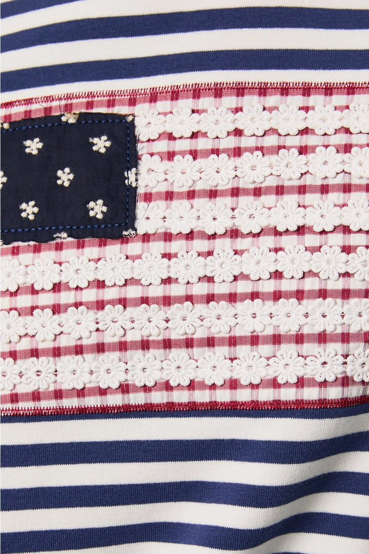Close up of navy and white stripe fabric with red and white lace detail flag