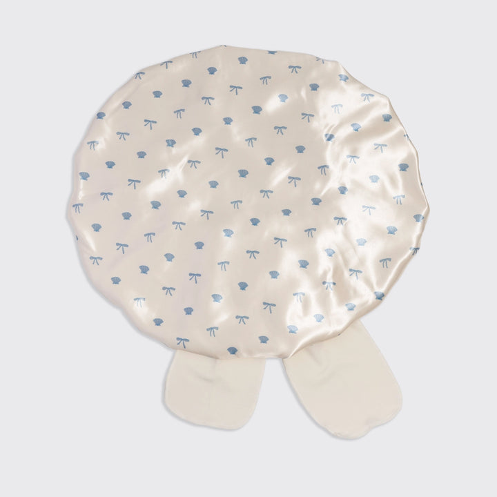 Beige fabric cover with blue patterns on a white background