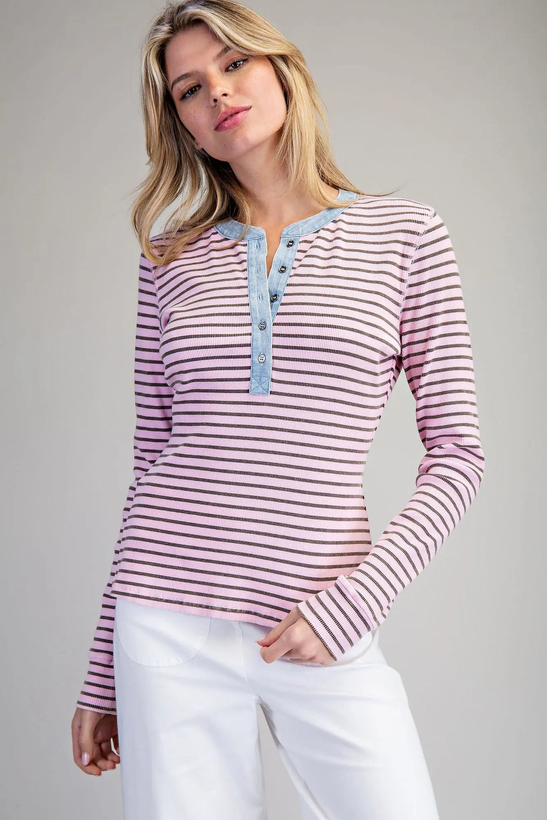 Woman wearing a striped long-sleeve shirt with a gray background