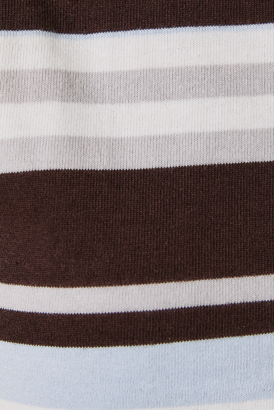 Close-up of a striped knit fabric with horizontal bands of dark brown, white, light gray, and pale blue.