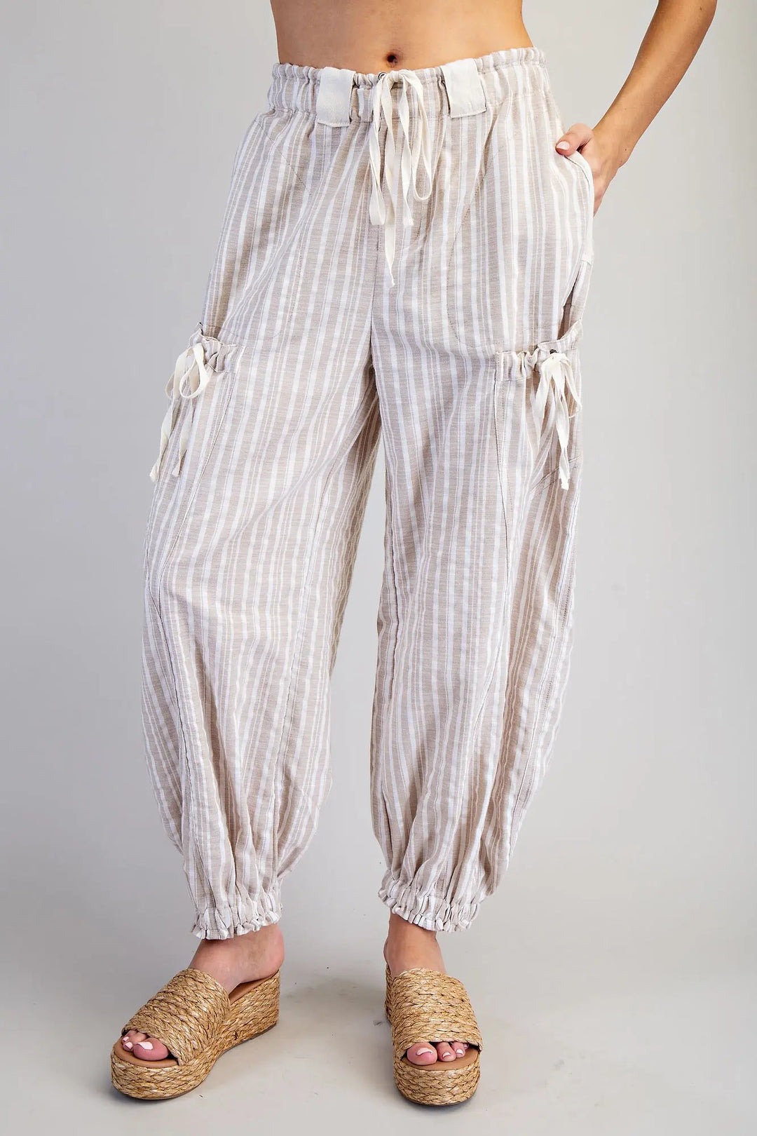 Striped pants worn by a person on a plain background
