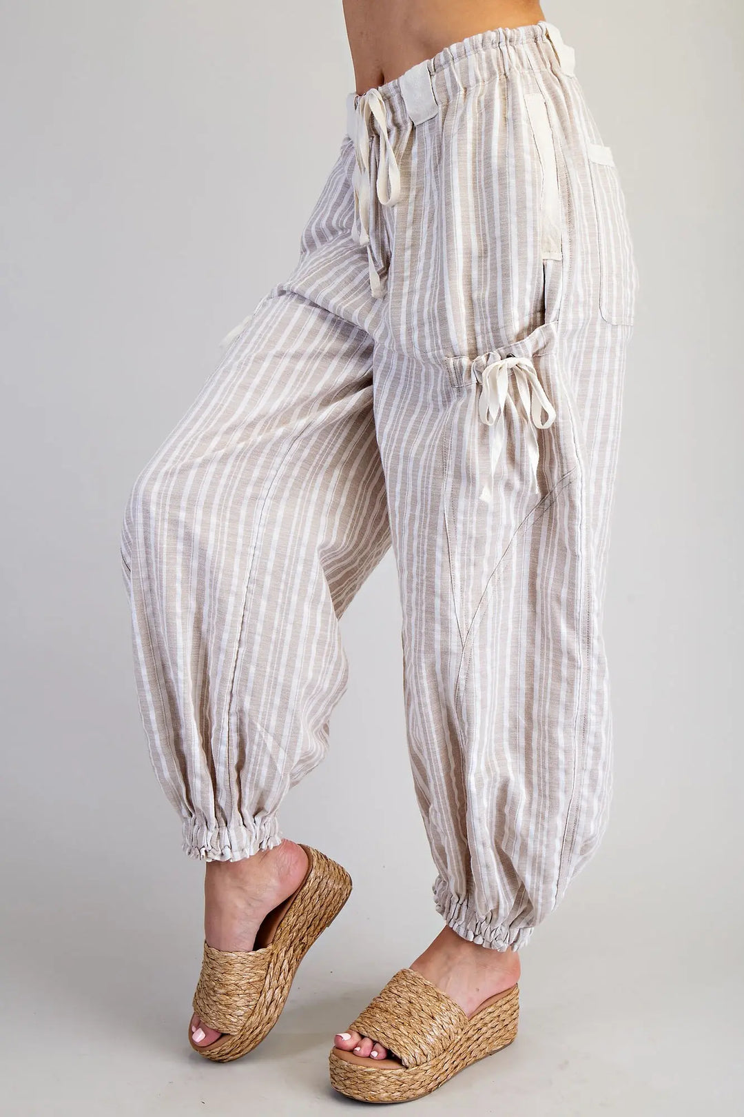 Striped harem pants worn by a person on a plain background