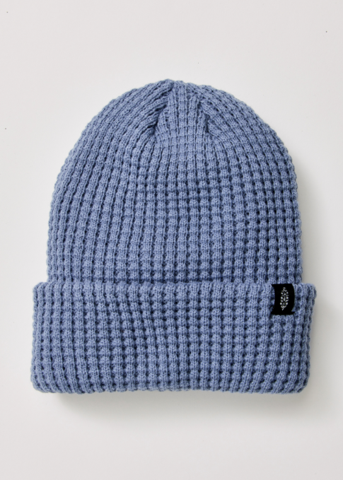 Single blue beanie with logo on plain background