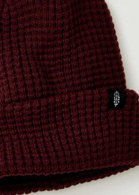 Single maroon beanie with logo on plain background