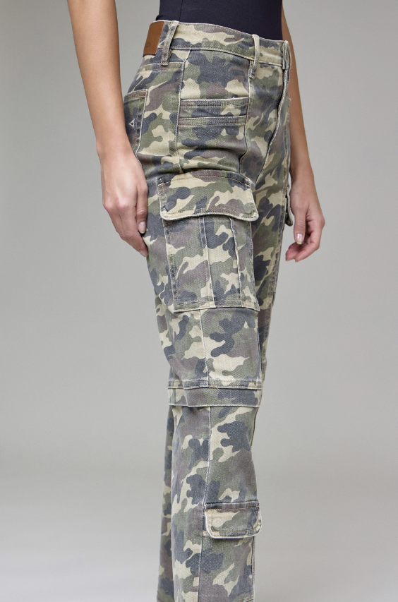 Camouflage pants worn by a person on a gray background