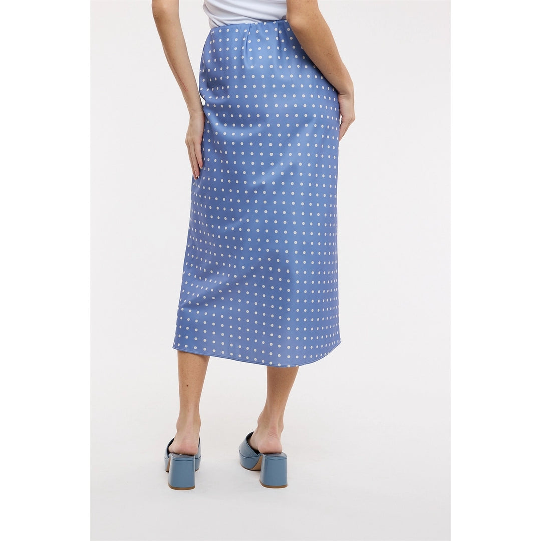Back of woman wearing blue polka dot midi satin skirt on plain background