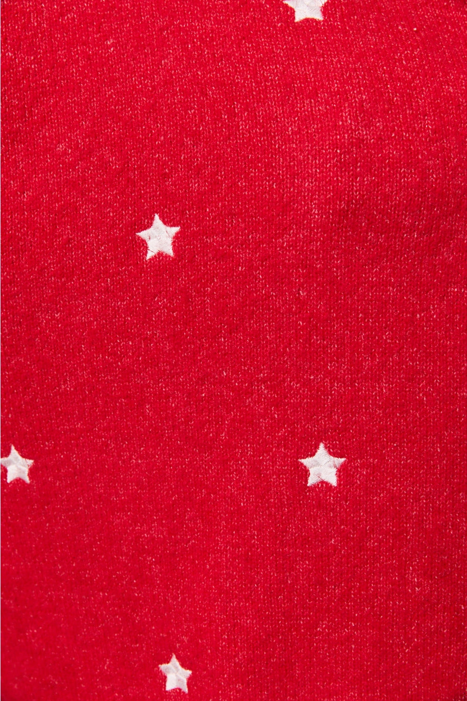 Close up of red cardigan with white stars