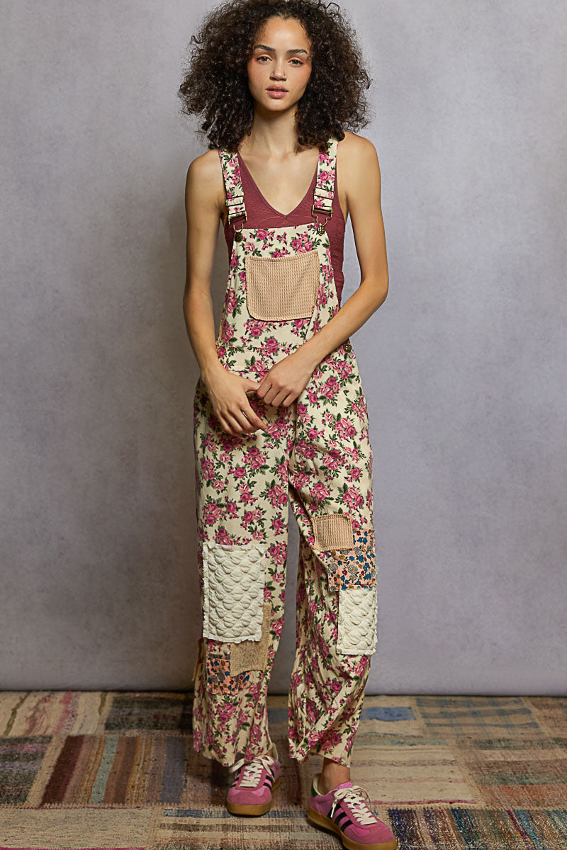 Woman wearing a floral overalls with a plain background