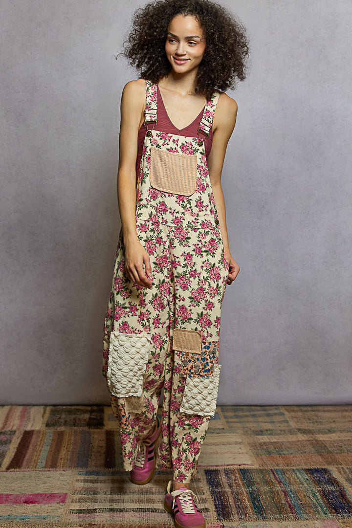 Woman wearing a floral overalls with a plain background