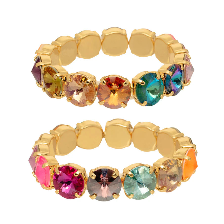 Gold bracelet with multicolored gemstones on a white background