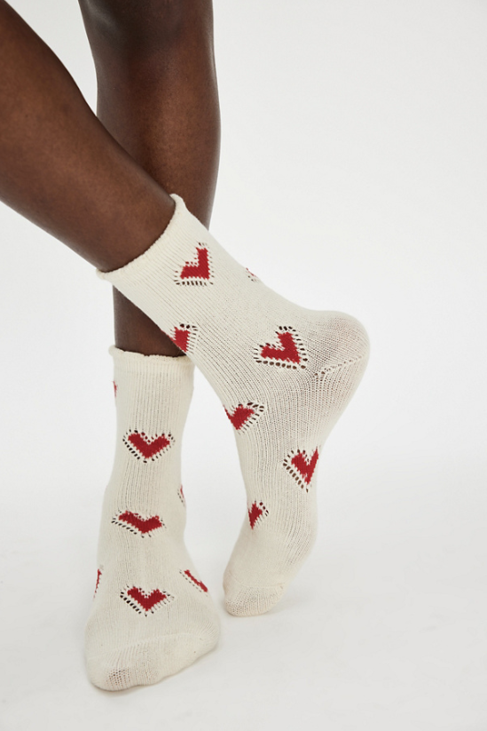 white socks with red hears on plain background
