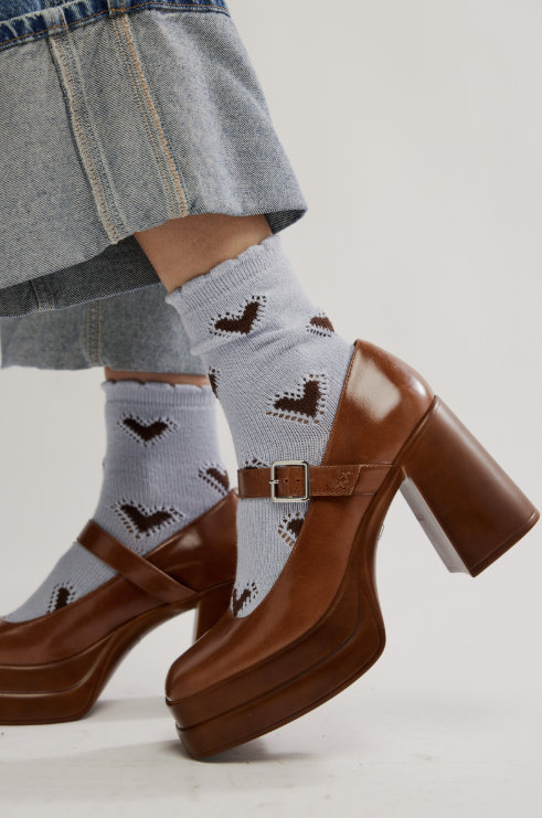 Blue socks with black hearts on plain background