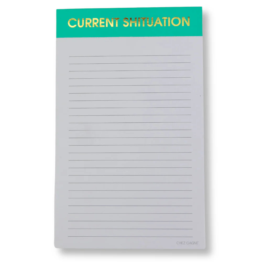 notepad with green top on white background