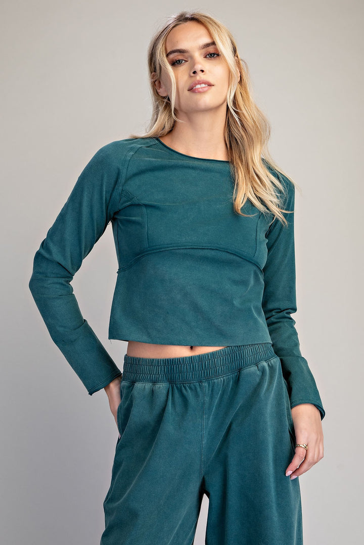 Woman wearing teal matching set on plain background