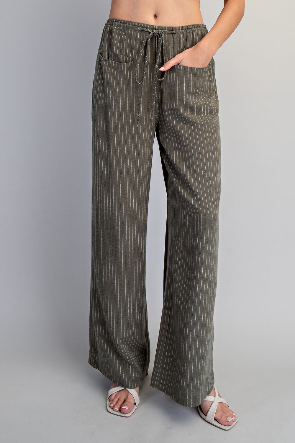 Striped wide-leg pants worn by a person on a plain background