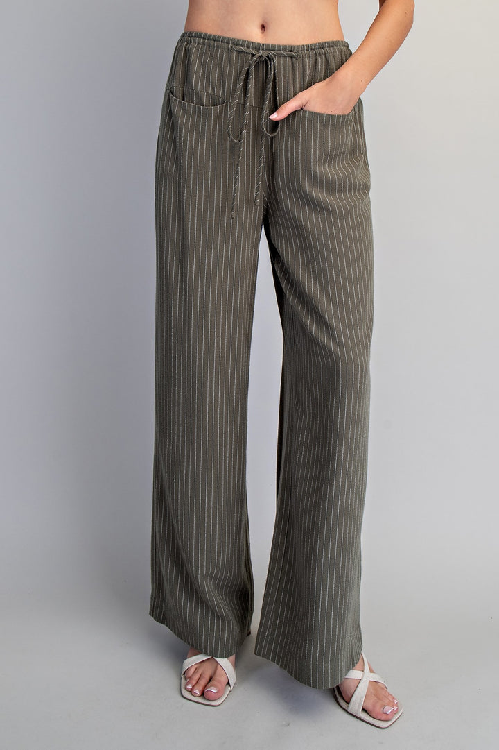 Striped wide-leg pants worn by a person on a plain background