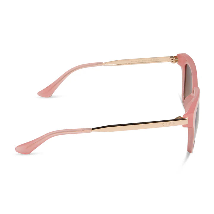 Pink sunglasses with gold frame on a white background