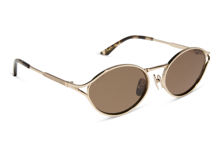 Pair of gold sunglasses with brown lens on white background