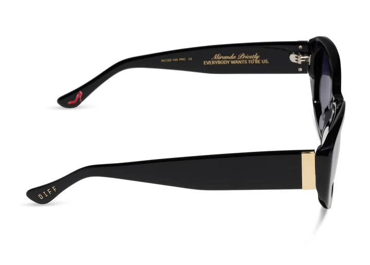 Pair of black sunglasses shown from the side with gold details on white background