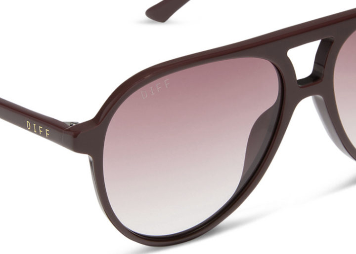Pair of red sunglasses with burgundy lenses on white background