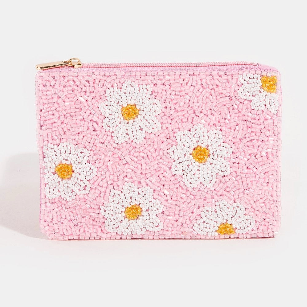 Pink pouch with white daisy patterns on a light gray background