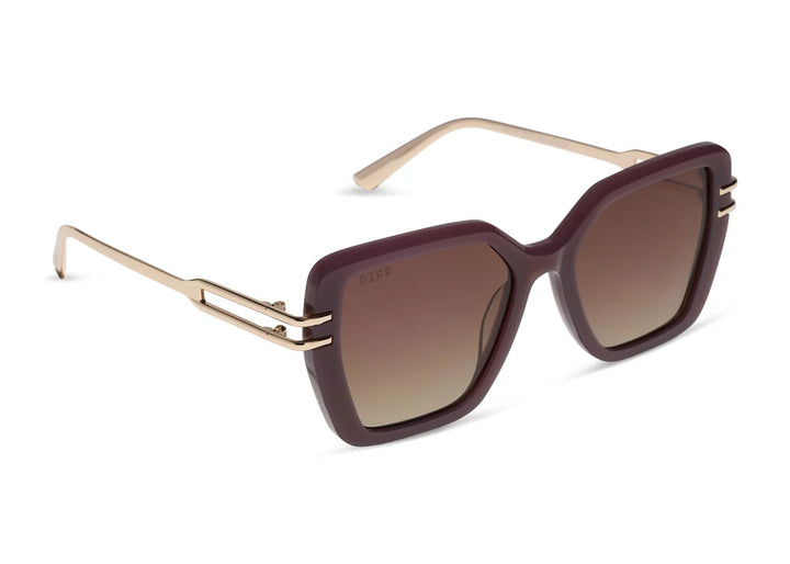 Pair of brown and gold sunglasses with brown gradient lenses on white background