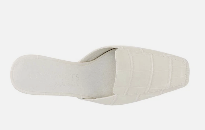 A single off-white mule sandal with a crocodile-embossed texture on the upper, shown from a top-down perspective against a light gray background.