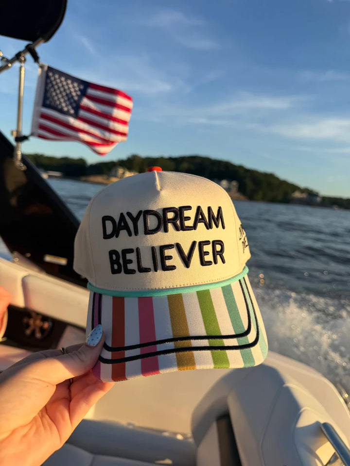 Hand holding colorful hat with &