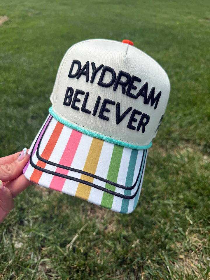 Hand holding colorful hat with &