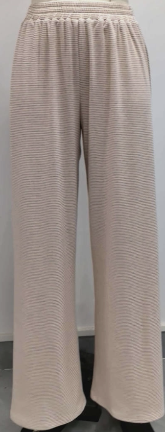 Woman wearing pink stripe pants on plain background