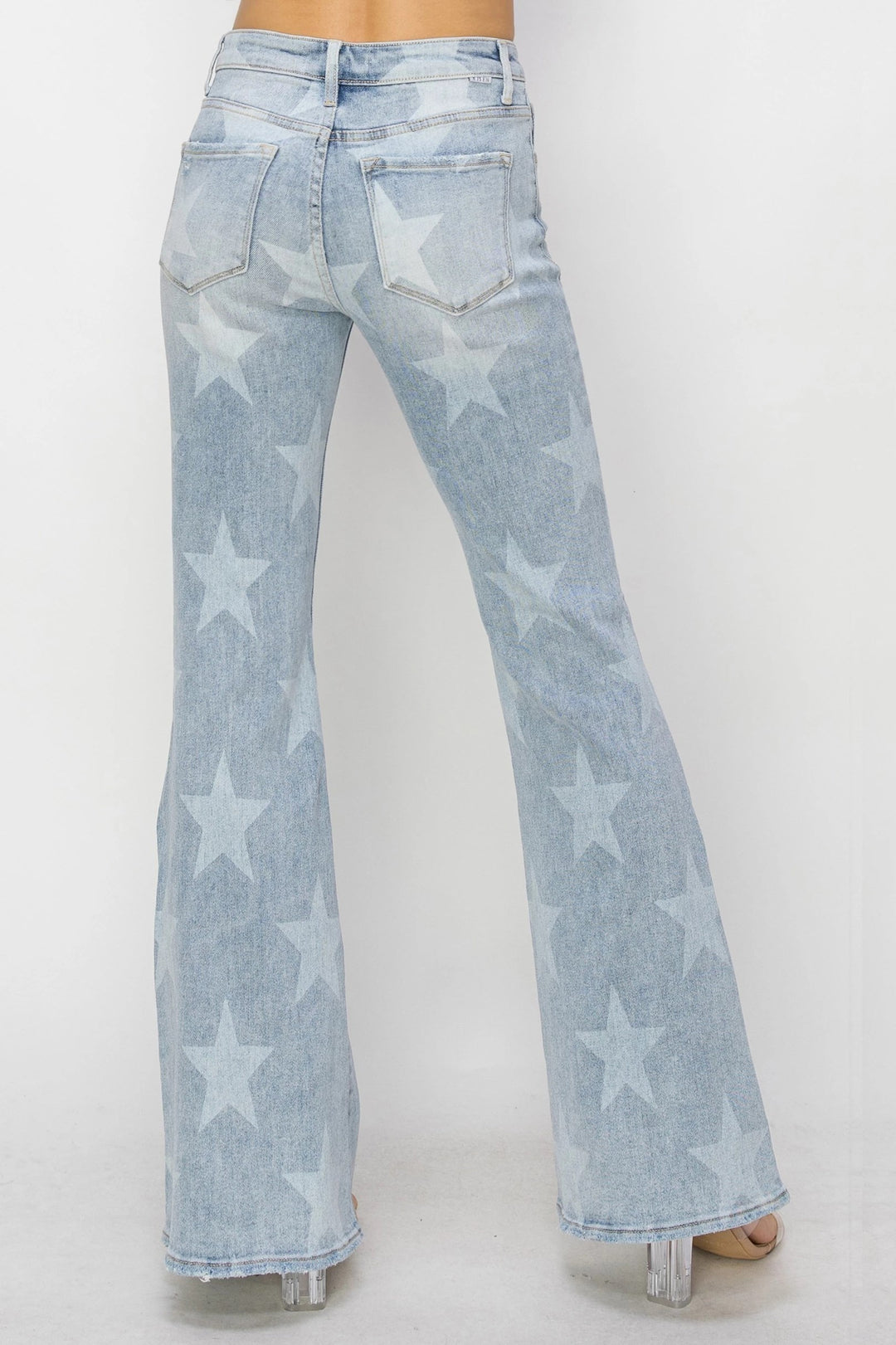 Light blue jeans with star patterns on a white background