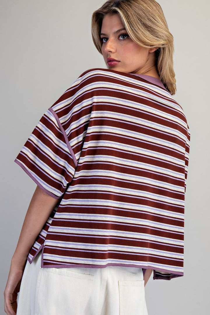 Woman wearing a striped shirt with a neutral background
