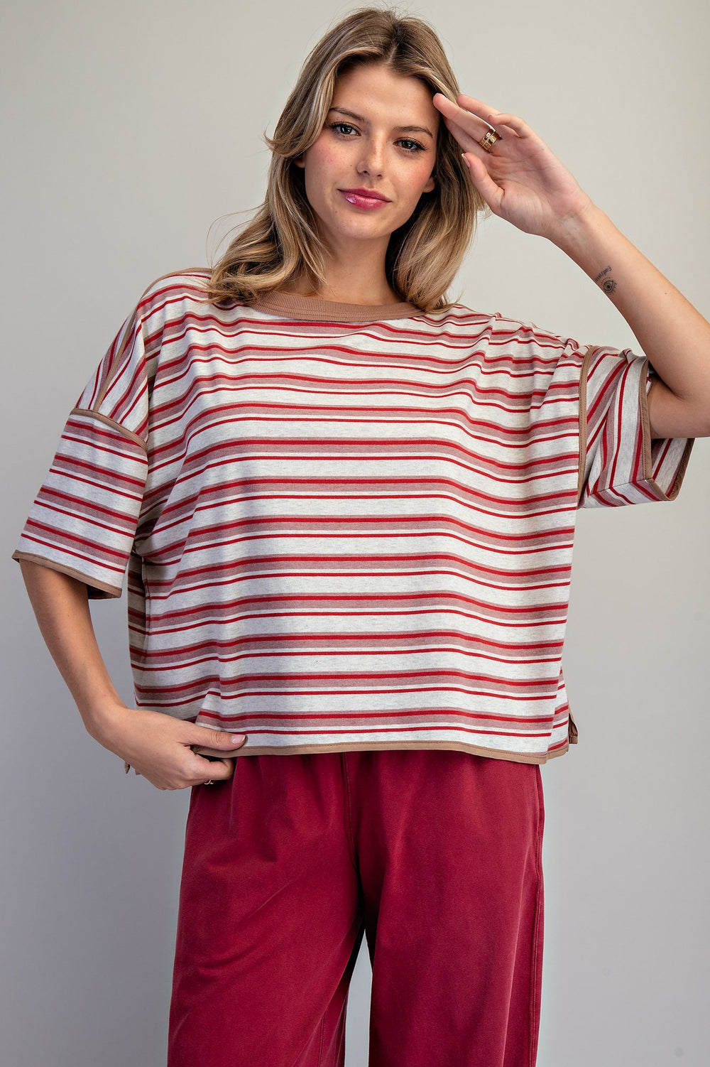 Woman wearing red stripe tee on plain background