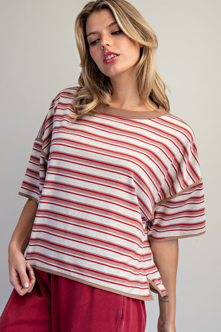 Woman wearing red stripe tee on plain background