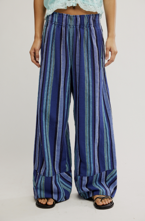 Woman wearing blue stripe pants on white background