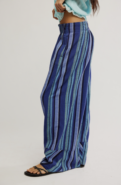 Blue striped pants worn by a person on a light gray background