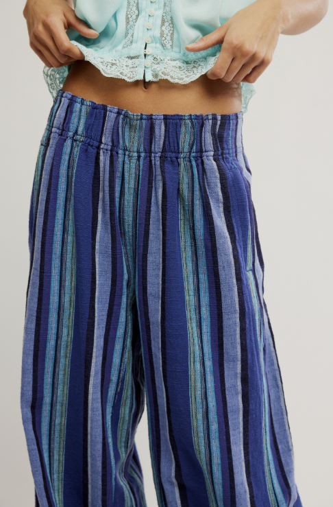 Woman wearing blue stripe pants on white background