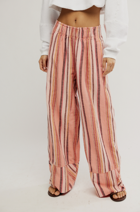 Woman wearing pink stripe pants on white background